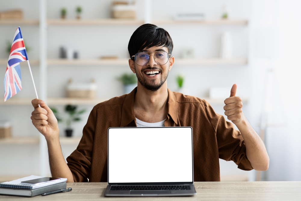 Mistakes People Make When Applying for a UK Visa: A picture showing a UK Visa applicant holding UK flag in excitement about the application process. 