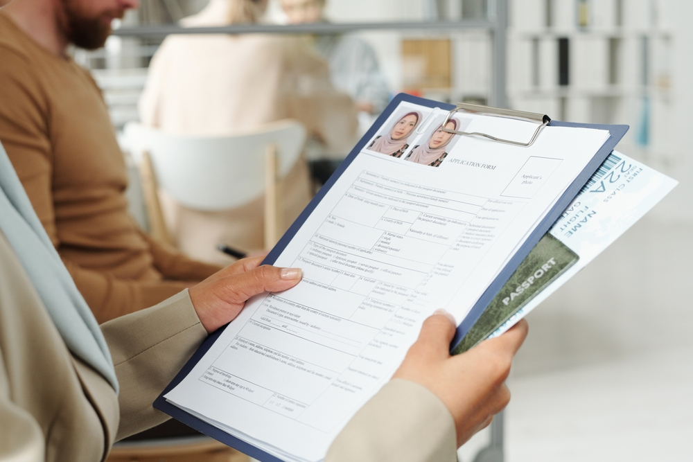 Things to Avoid During the UK Visa Application Process: A picture showing UK Visa applicant waiting in queue for interview with consular officer.