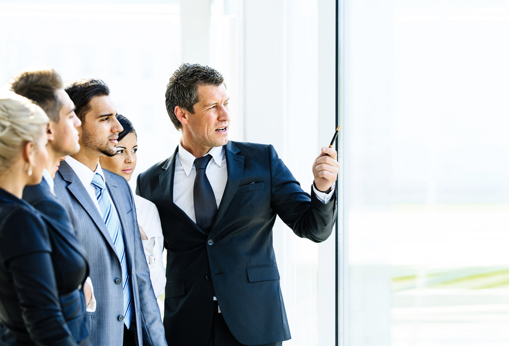 UK Work Culture Shockers: Business seminar where a boss explaining the company strategy to his colleagues. 
