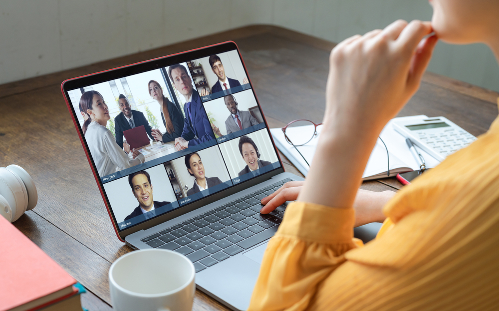 Secrets to Creating a Standout Remote Job Resume: Picture of a female freelancer having a zoom meeting on her laptop. 