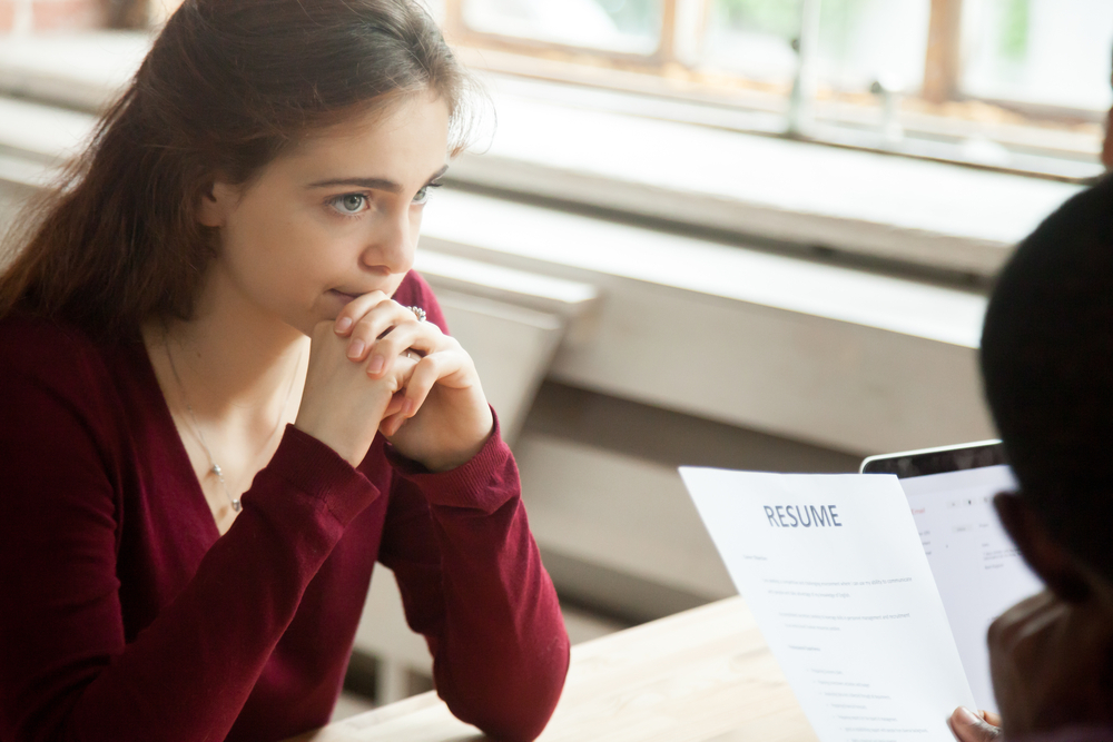 First-Time Job Seekers in Canada: A picture showing a job seeker sitting before a recruiter, anxious of feedback on her resume assessment.