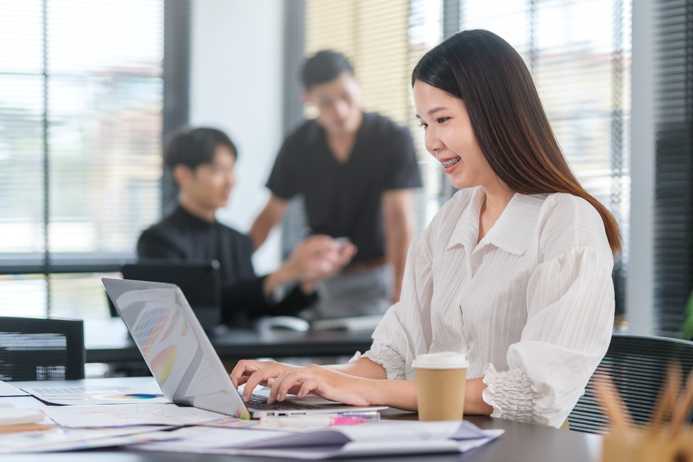 Remote Jobs vs. Office Jobs: Which is Better for Your Career: Group of creative businesspeople working together on a project in the office. 