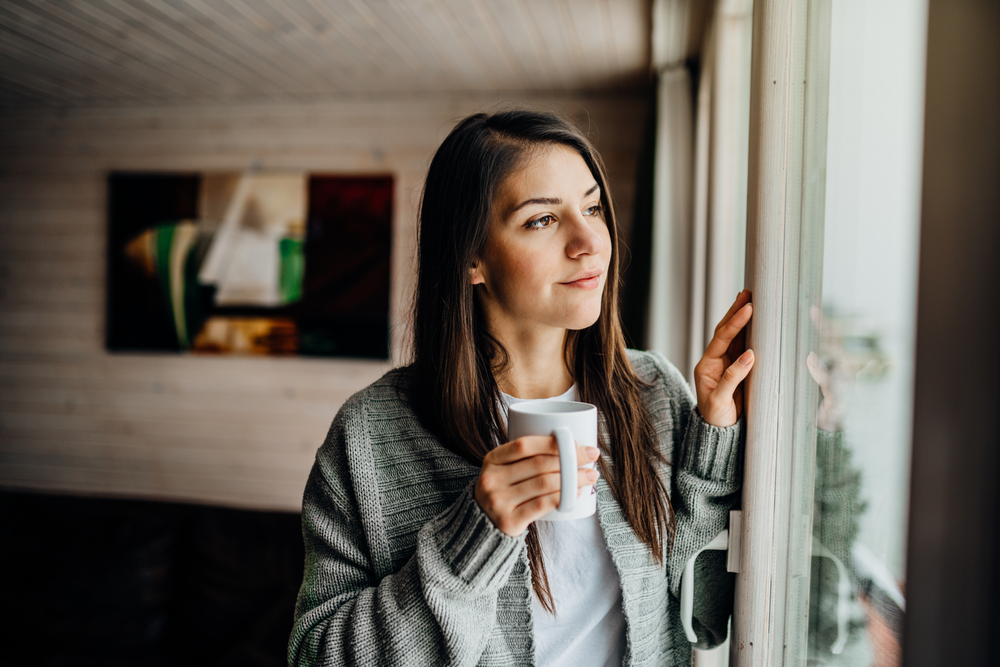 Ways to Avoid Remote Work Pitfalls: Picture of a female freelancer practicing self care after working remotely.