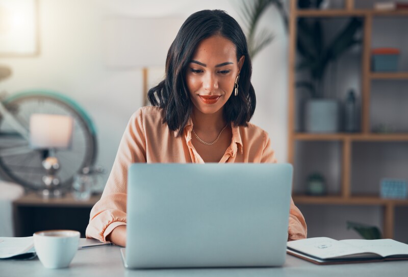 Secure your dream remote job at Pearson: Picture of a smiling happy lady working from home